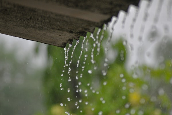 Rain gutter with water flowing during storm