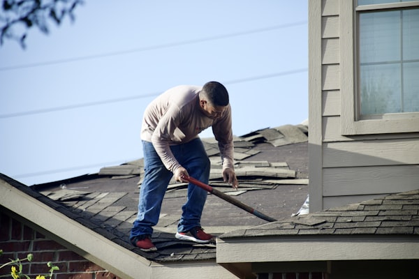 Roofer performing a full roof tear-off