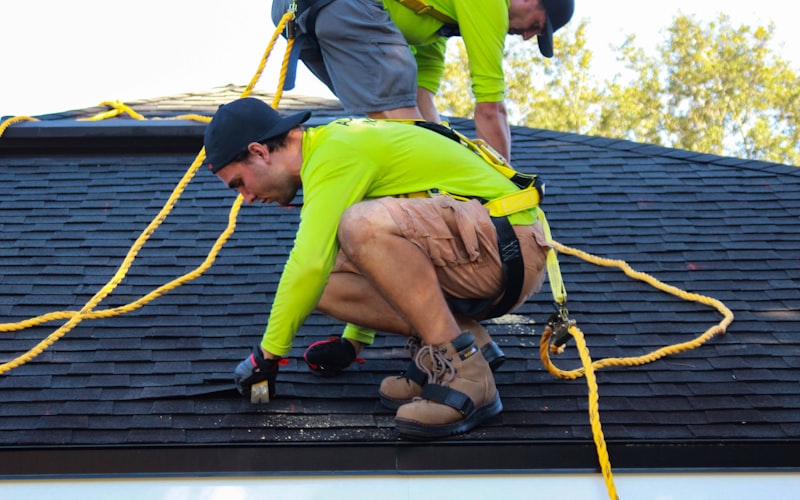 Roofing crew working together on a residential roof